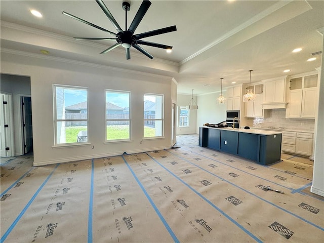 11517 Willowood Creek Dr, Corpus Christi, TX 78410 - kitchen featuring plenty of natural light, stainless steel microwave, ornamental molding, decorative backsplash, and a ceiling fan