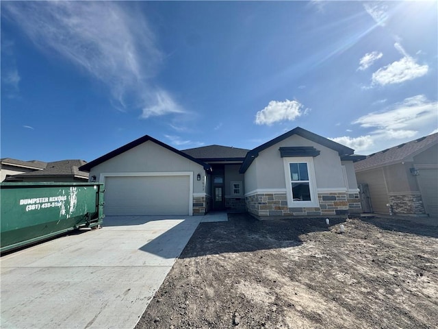 11517 Willowood Creek Dr, Corpus Christi, TX 78410 - ranch-style house featuring stucco siding, stone siding, a garage, and driveway