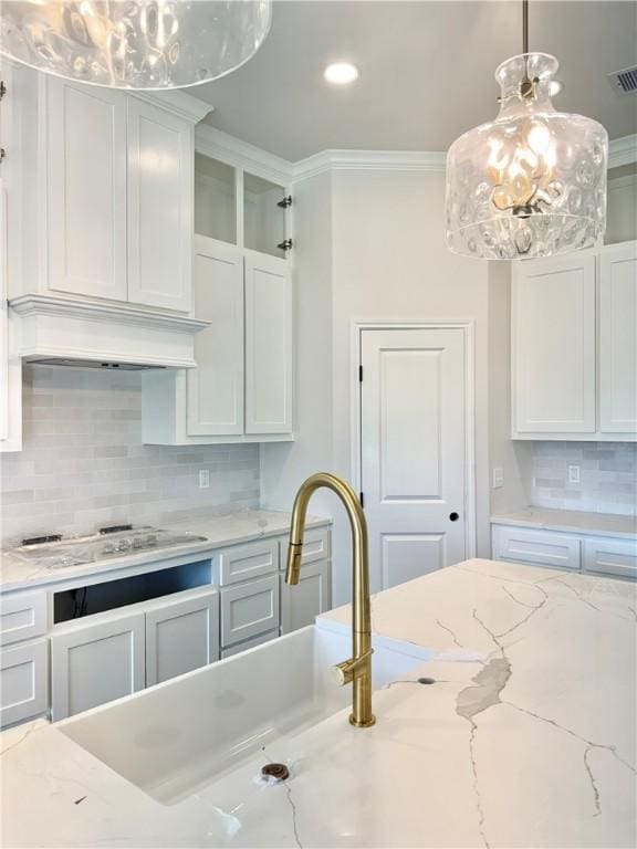 11517 Willowood Creek Dr, Corpus Christi, TX 78410 - kitchen featuring white cabinets, tasteful backsplash, crown molding, and glass insert cabinets