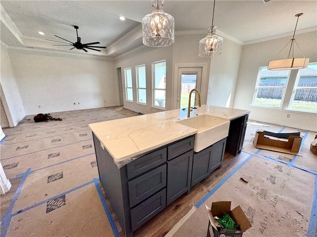11517 Willowood Creek Dr, Corpus Christi, TX 78410 - kitchen featuring healthy amount of natural light, crown molding, an island with sink, light stone counters, and decorative light fixtures