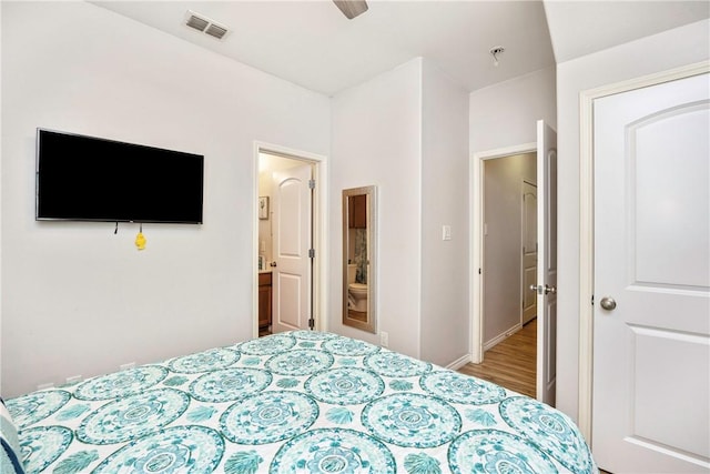 bedroom featuring ensuite bathroom, ceiling fan, and hardwood / wood-style flooring