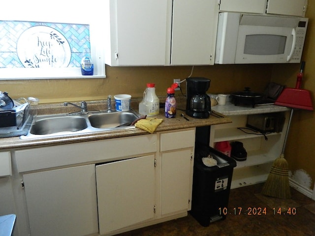 kitchen featuring white cabinetry and sink