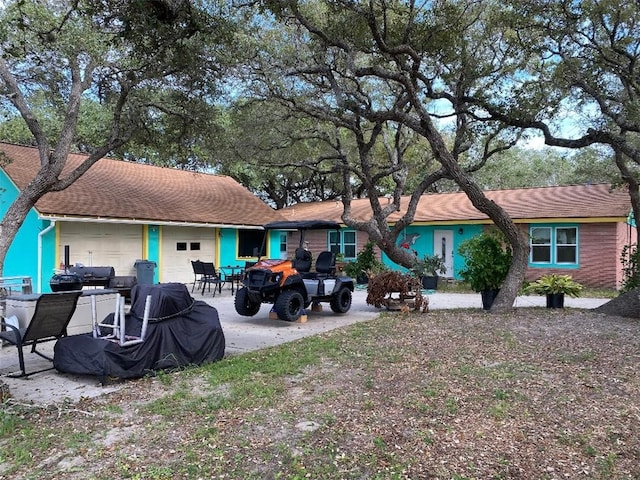 back of house featuring a garage