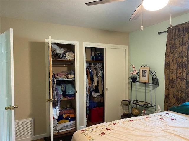 bedroom featuring multiple closets and ceiling fan