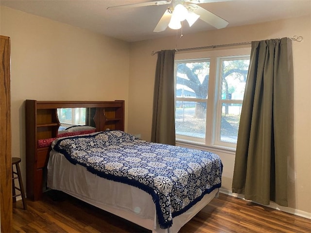 bedroom featuring ceiling fan and dark hardwood / wood-style floors