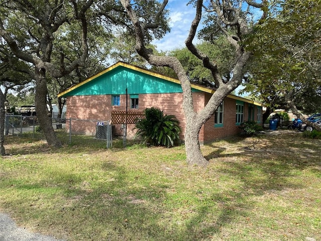 view of side of home featuring a lawn