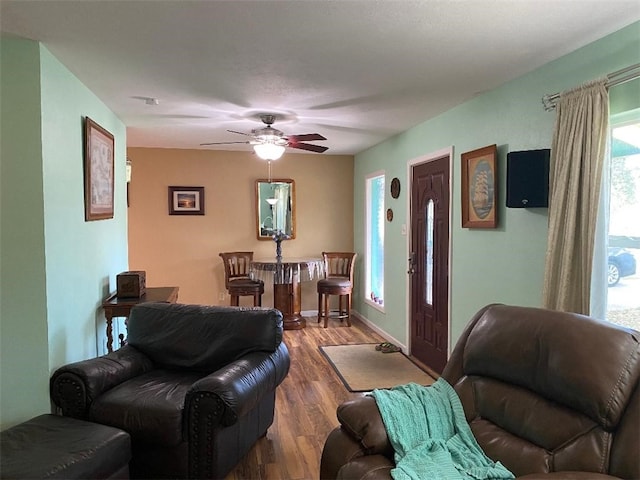 living room with wood-type flooring and ceiling fan