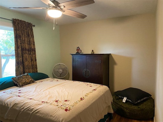 bedroom with hardwood / wood-style flooring and ceiling fan