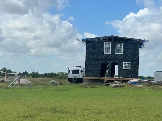 rear view of property featuring a yard