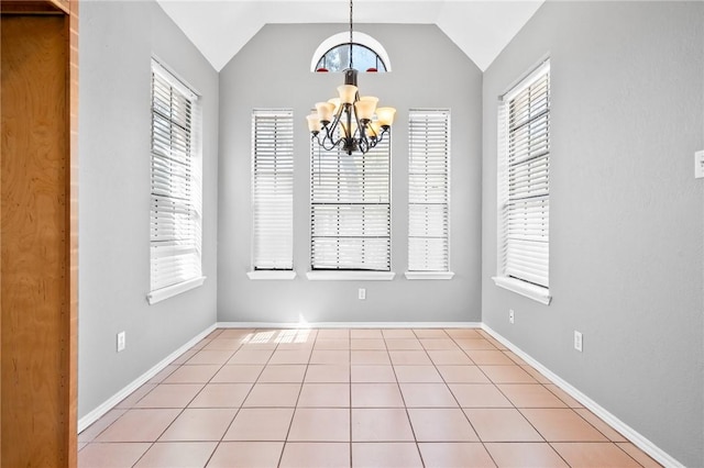 unfurnished dining area featuring lofted ceiling, tile patterned floors, a wealth of natural light, and an inviting chandelier