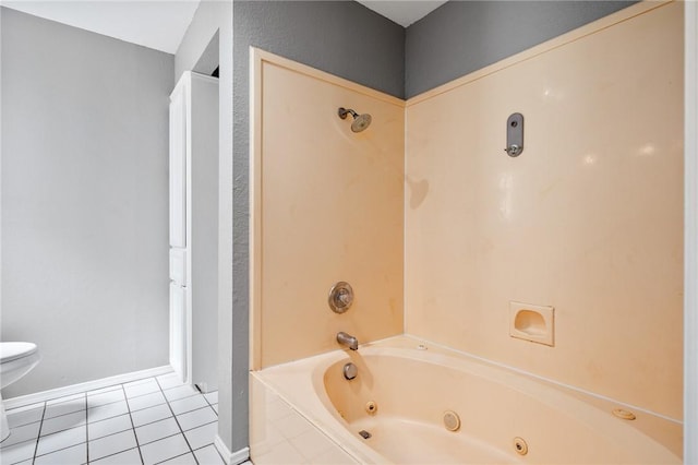 bathroom featuring a combined bath / shower with jetted tub, baseboards, toilet, and tile patterned floors