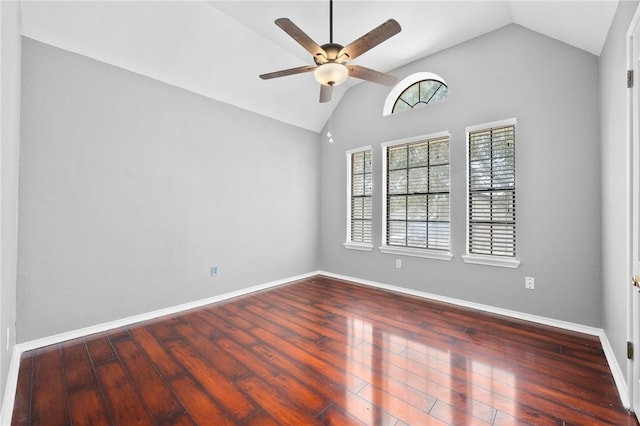 empty room featuring lofted ceiling, ceiling fan, baseboards, and wood finished floors