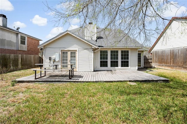 back of house featuring a yard, a fenced backyard, a wooden deck, and french doors