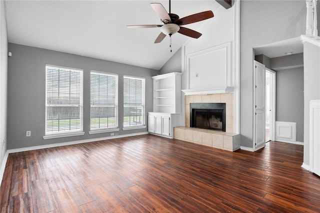 unfurnished living room featuring ceiling fan, high vaulted ceiling, a fireplace, baseboards, and dark wood finished floors