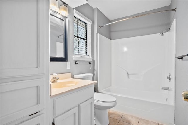 bathroom featuring vanity, bathing tub / shower combination, tile patterned flooring, and toilet