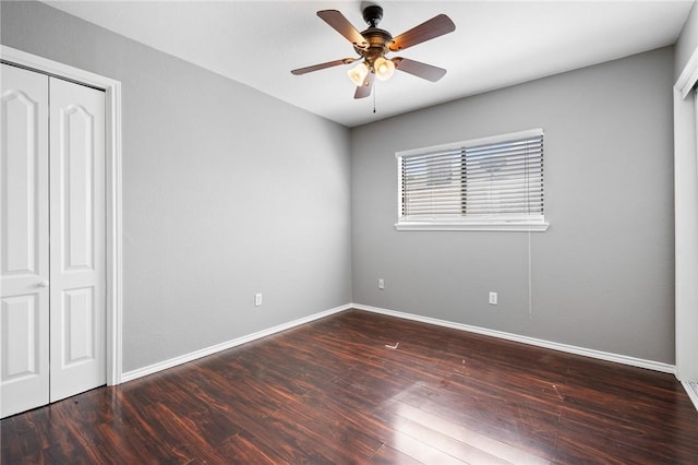 unfurnished bedroom featuring a closet, ceiling fan, baseboards, and wood finished floors