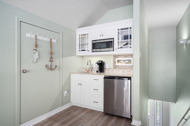 kitchen featuring glass insert cabinets, dark wood-style flooring, white cabinets, stainless steel appliances, and a sink