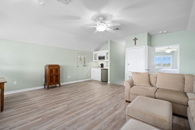 unfurnished living room with lofted ceiling, ceiling fan, and light wood-type flooring