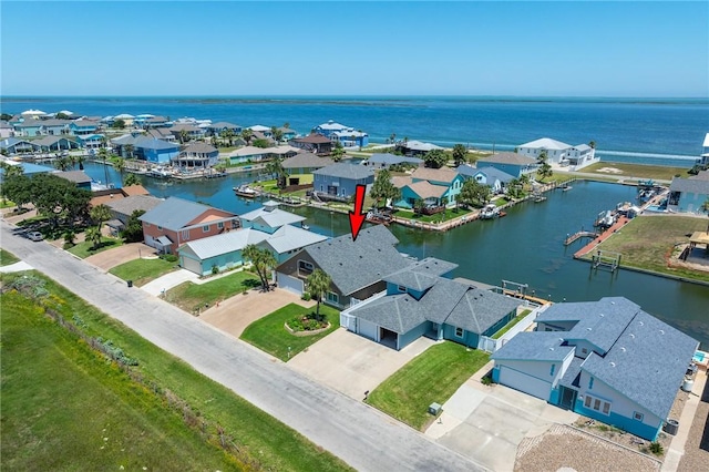 drone / aerial view featuring a residential view and a water view