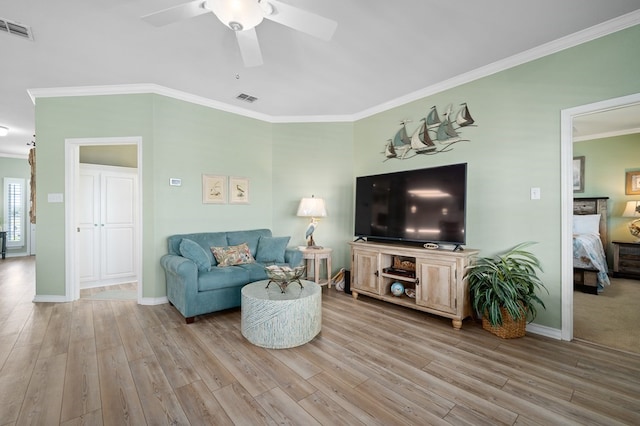 living room with crown molding, ceiling fan, and light hardwood / wood-style flooring