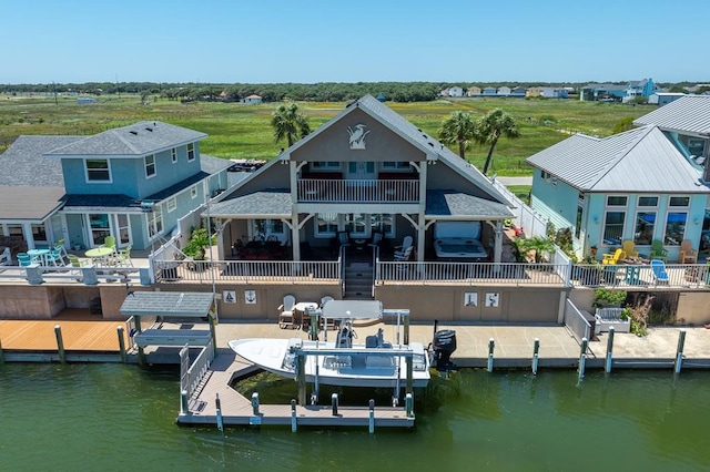316 Lands End St, Rockport, TX 78382 - view of dock featuring boat lift, a patio, and a water view