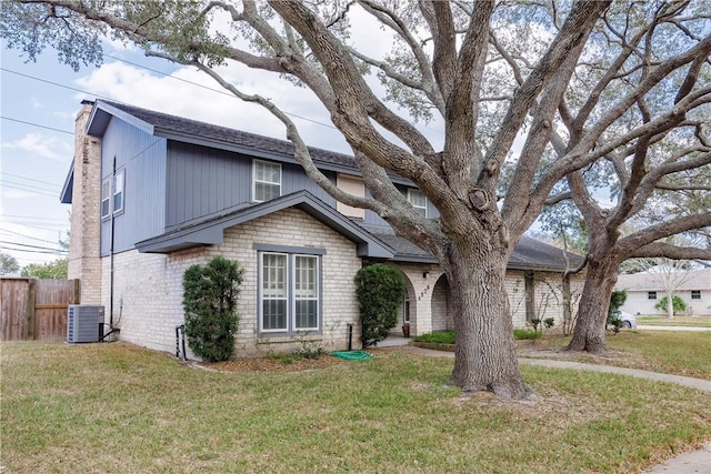 view of front facade with cooling unit and a front lawn