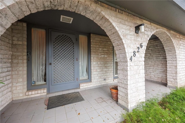 4826 Olympia Dr, Corpus Christi, TX 78413 - property entrance featuring covered porch and brick siding