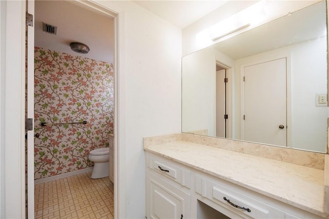 bathroom with vanity and toilet