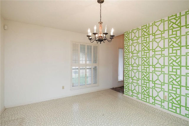 unfurnished room featuring a notable chandelier