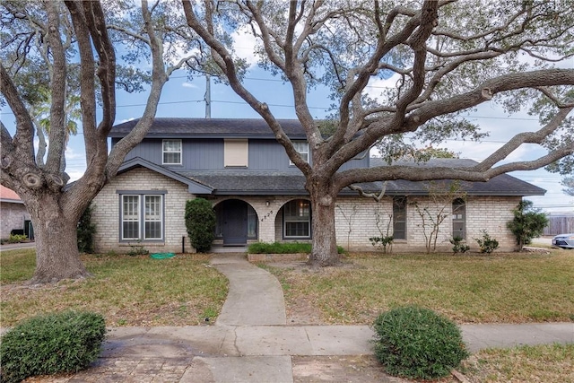 4826 Olympia Dr, Corpus Christi, TX 78413 - traditional home featuring a front yard, a shingled roof, and covered porch