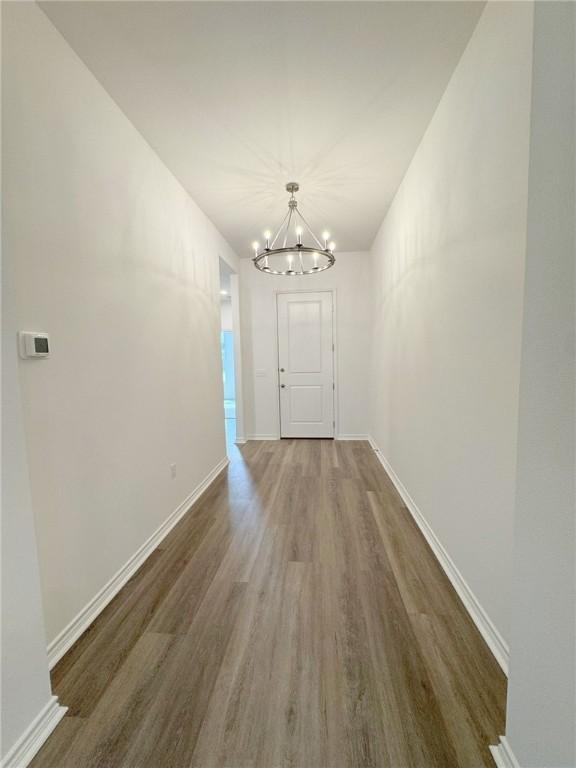 130 Broad Oak Dr, Rockport, TX 78382 - corridor with a chandelier and wood finished floors