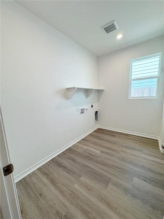 130 Broad Oak Dr, Rockport, TX 78382 - laundry room featuring washer hookup, hookup for an electric dryer, wood finished floors, recessed lighting, and gas dryer hookup