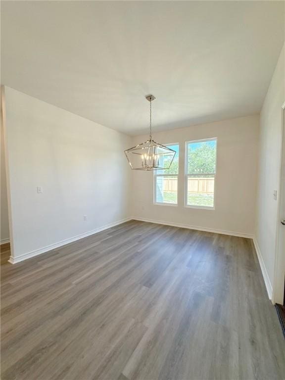 130 Broad Oak Dr, Rockport, TX 78382 - unfurnished room with a chandelier and dark wood-style flooring