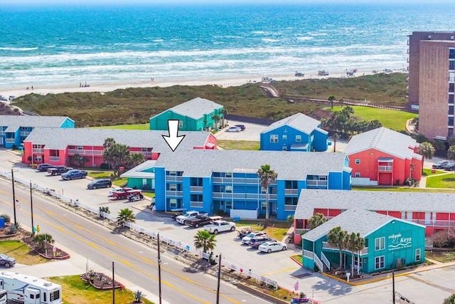 birds eye view of property with a water view and a view of the beach