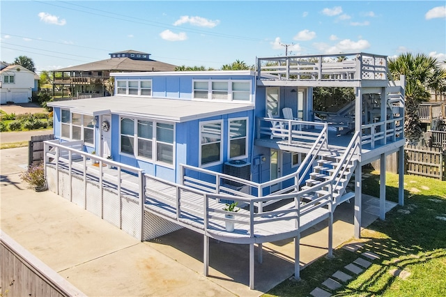 back of property with a patio and a sunroom