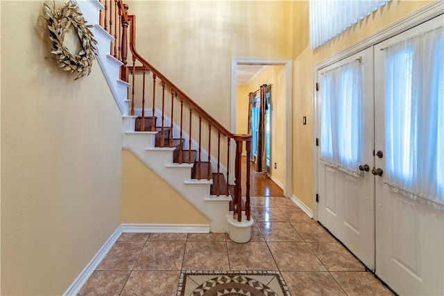 foyer entrance featuring french doors and tile patterned flooring