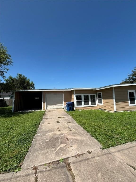4342 Amherst Dr, Corpus Christi, TX 78412 - view of front of home with a front yard, an attached garage, and driveway