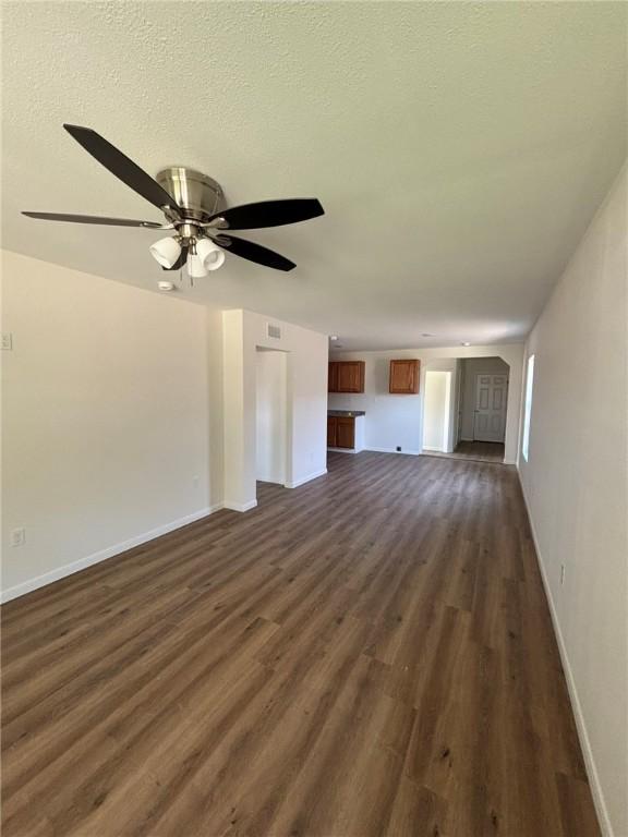 4342 Amherst Dr, Corpus Christi, TX 78412 - unfurnished living room featuring dark wood-style flooring and a ceiling fan