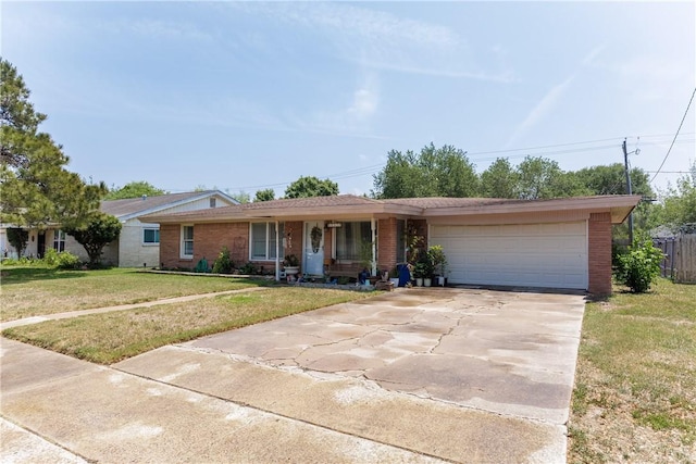 10639 Emmord Loop, Corpus Christi, TX 78410 - ranch-style house featuring brick siding, concrete driveway, a garage, and a front lawn
