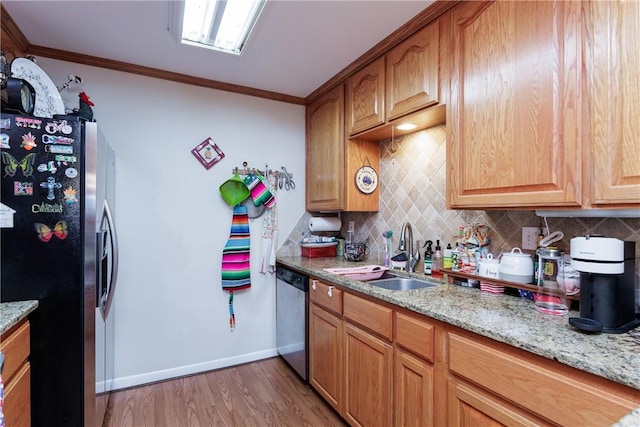 10639 Emmord Loop, Corpus Christi, TX 78410 - kitchen featuring appliances with stainless steel finishes, a sink, tasteful backsplash, light wood-style flooring, and ornamental molding