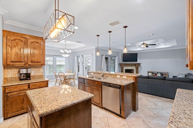 kitchen featuring visible vents, dishwasher, a sink, a raised ceiling, and an island with sink