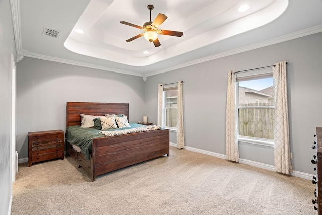 bedroom featuring carpet flooring, recessed lighting, a tray ceiling, visible vents, and ornamental molding
