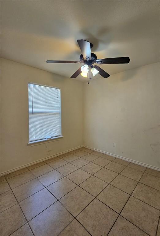 4318 Ivy, Corpus Christi, TX 78415 - empty room with light tile patterned floors, a ceiling fan, and baseboards