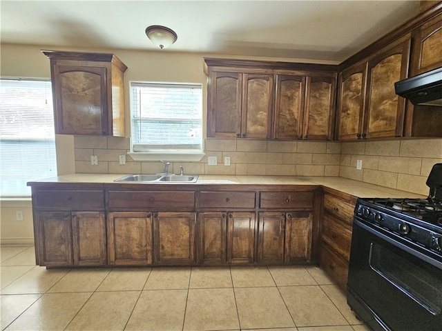 4318 Ivy, Corpus Christi, TX 78415 - kitchen with black gas stove, a sink, light countertops, tasteful backsplash, and light tile patterned flooring
