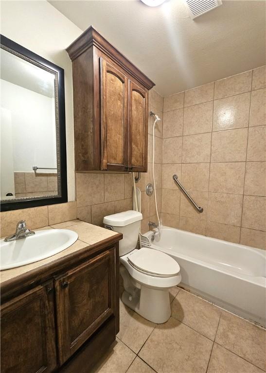 4318 Ivy, Corpus Christi, TX 78415 - bathroom featuring toilet, vanity, shower / tub combination, tile patterned floors, and backsplash