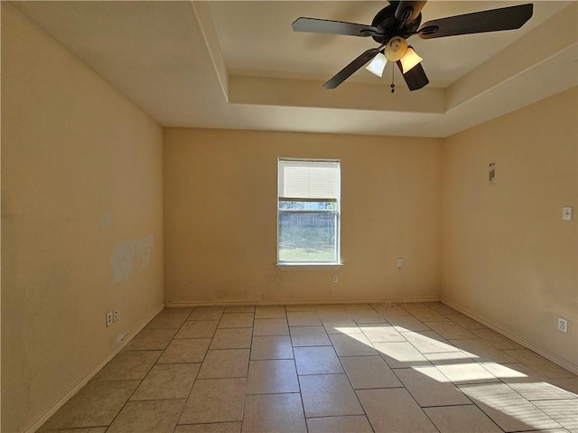4318 Ivy, Corpus Christi, TX 78415 - empty room featuring a tray ceiling, light tile patterned flooring, a ceiling fan, and baseboards