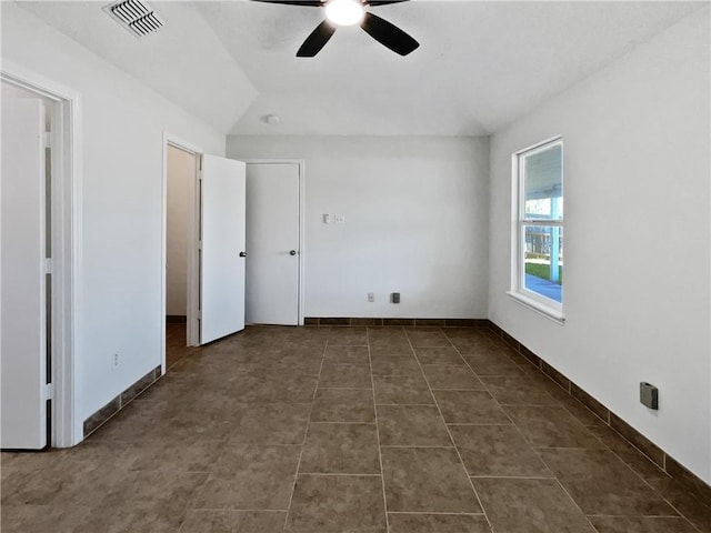 2613 Raintree Trl, Ingleside, TX 78362 - unfurnished bedroom with lofted ceiling, baseboards, dark tile patterned flooring, ceiling fan, and visible vents