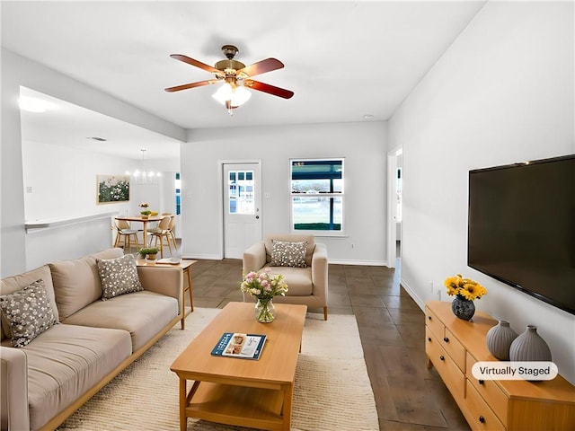2613 Raintree Trl, Ingleside, TX 78362 - living room with ceiling fan with notable chandelier and baseboards