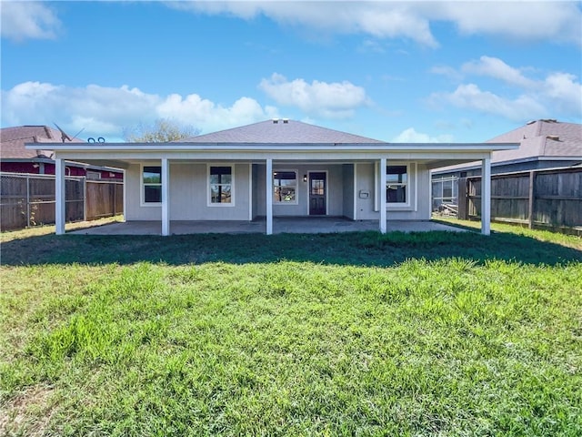 2613 Raintree Trl, Ingleside, TX 78362 - back of house featuring a lawn, fence, and a patio