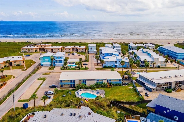 birds eye view of property with a beach view and a water view